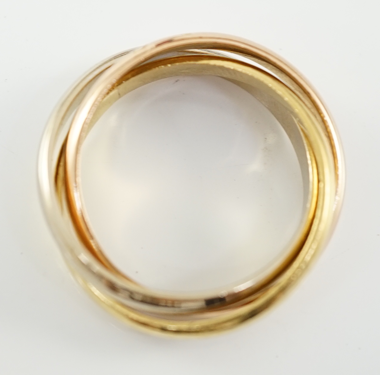 A Le Must De Cartier three colour 18ct gold Trinity ring